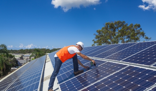 Technician installing solar panels